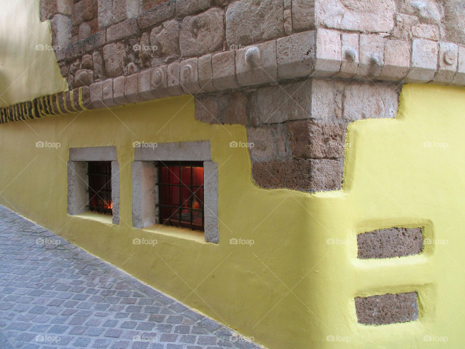 Greek Islands Style Decorated Yellow Stone Wall in the Old Town of Chania, Crete Island of Greece