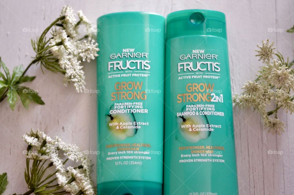 Garnier grow strong conditioner and shampoo Flat lay on a white background