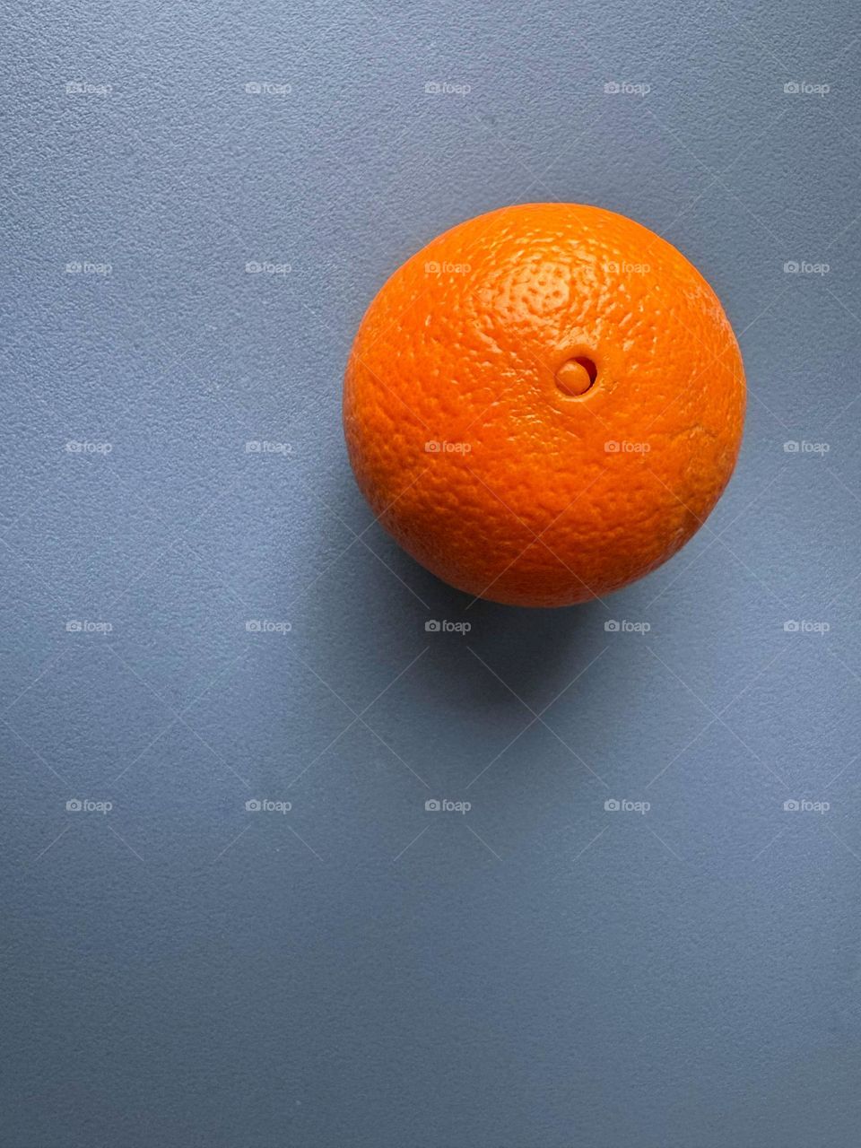 Orange on a blue cutting board