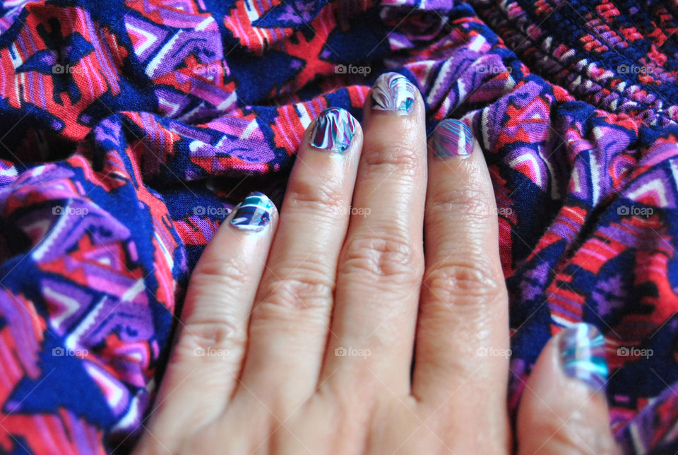 water marble nail art in purple, magenta, bluegreen and white