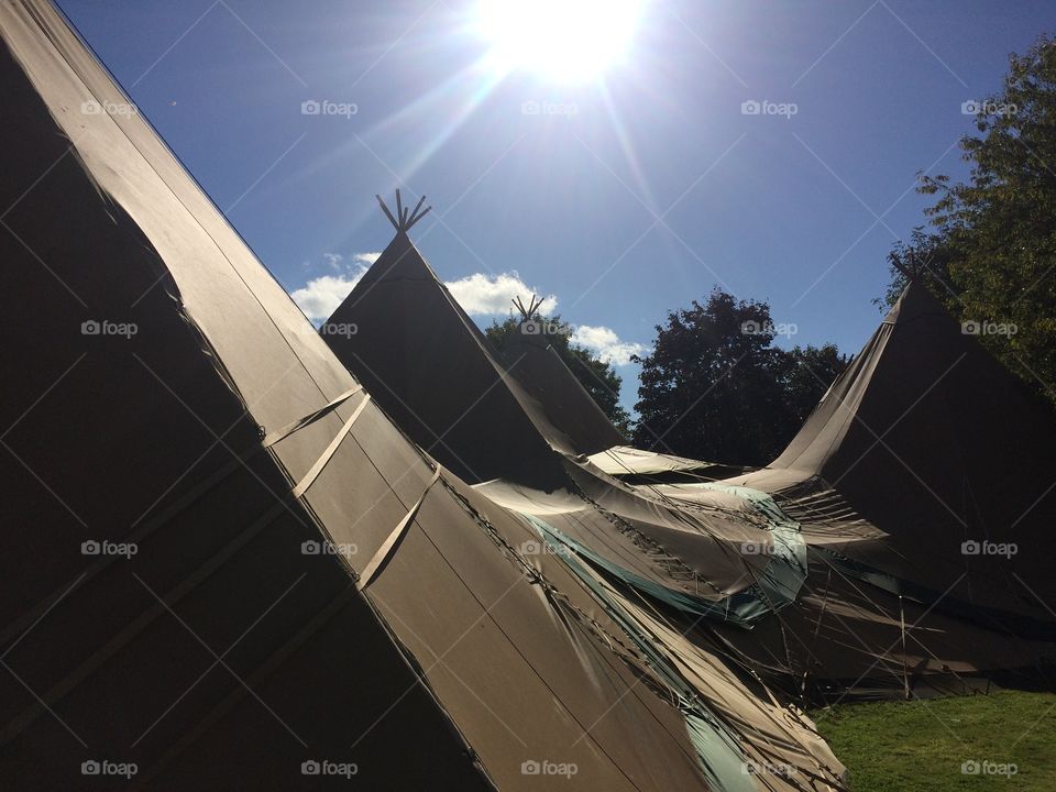After a night of rain, the canvases were covered in sunlight and brought to life. Throughout the day the tents were tightened and ready for the wedding within 