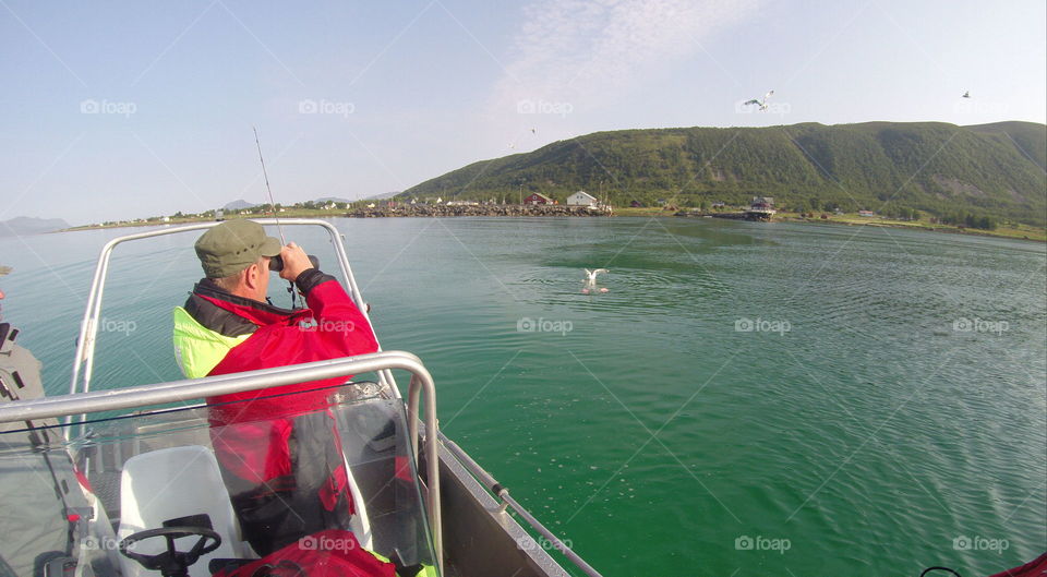 Morning in Norway. We just are going to start fishing. My friend is watching of where the seagulls are. Usually they are there where the fish is. 