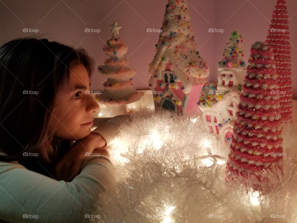 This little girl is so captivated by these beautiful Christmas decorations.  If only she could see what's going on through those gumdrop windows.
