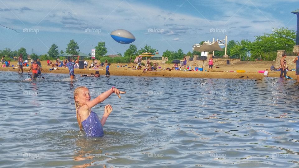throwing football at the beach