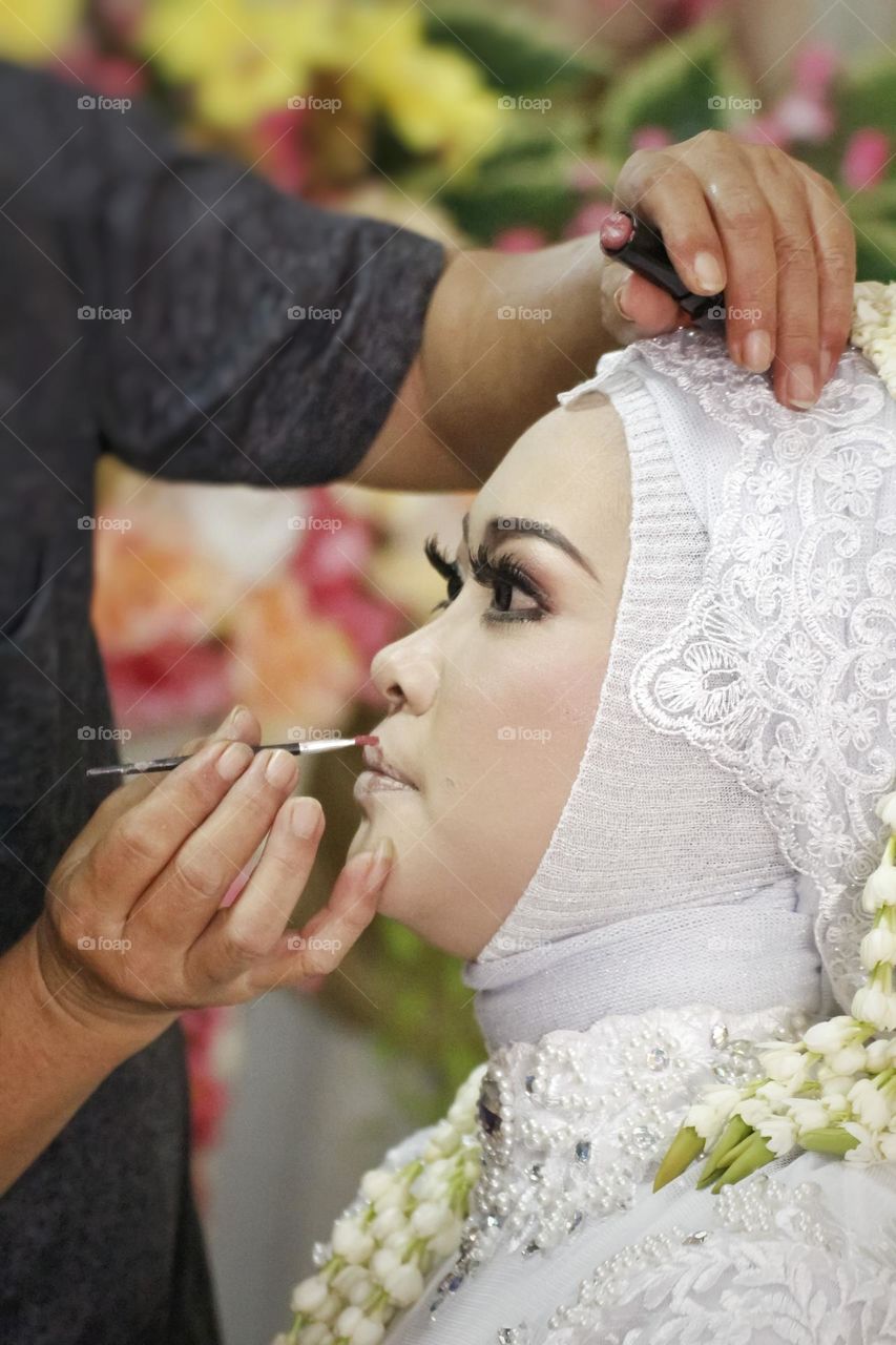 Making up the Bride for wedding ceremony. Siger is a crown by sundanese bridal