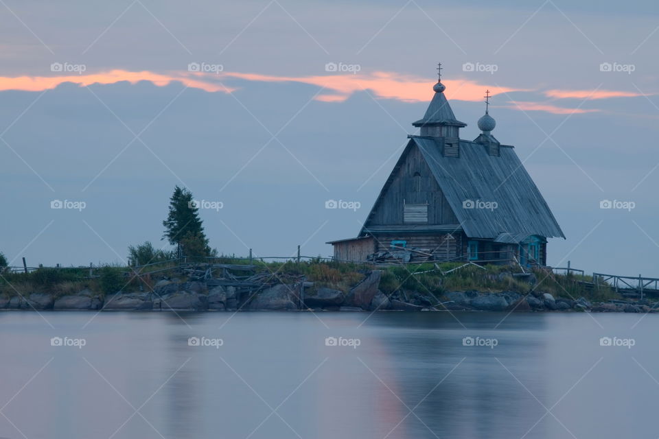 White Sea at early motning. Wooden church in Rabocheostrovsk, Kem, Russia