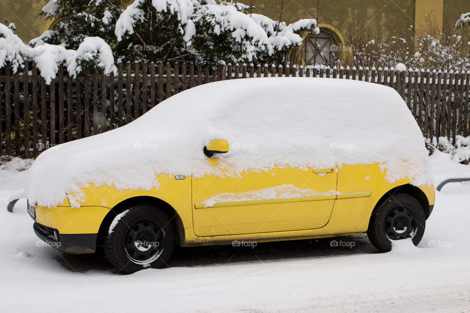 Yellow car in snow 