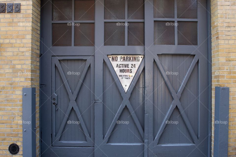 Grey garage doors on brick building 