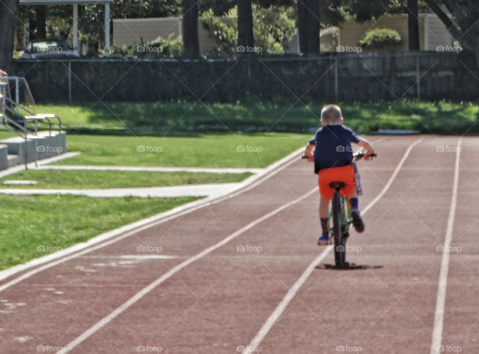 Boy Racing His Bicycle
