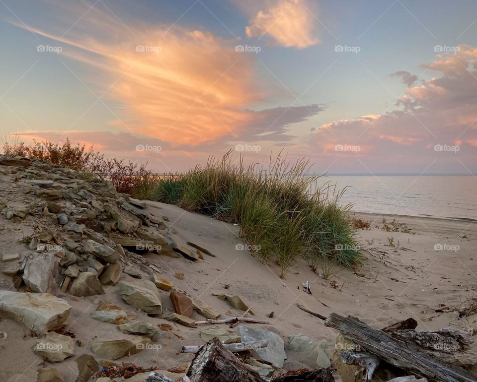 Lake Eerie purple and pink Sunset from Cedar Point Shores rocky sand beach