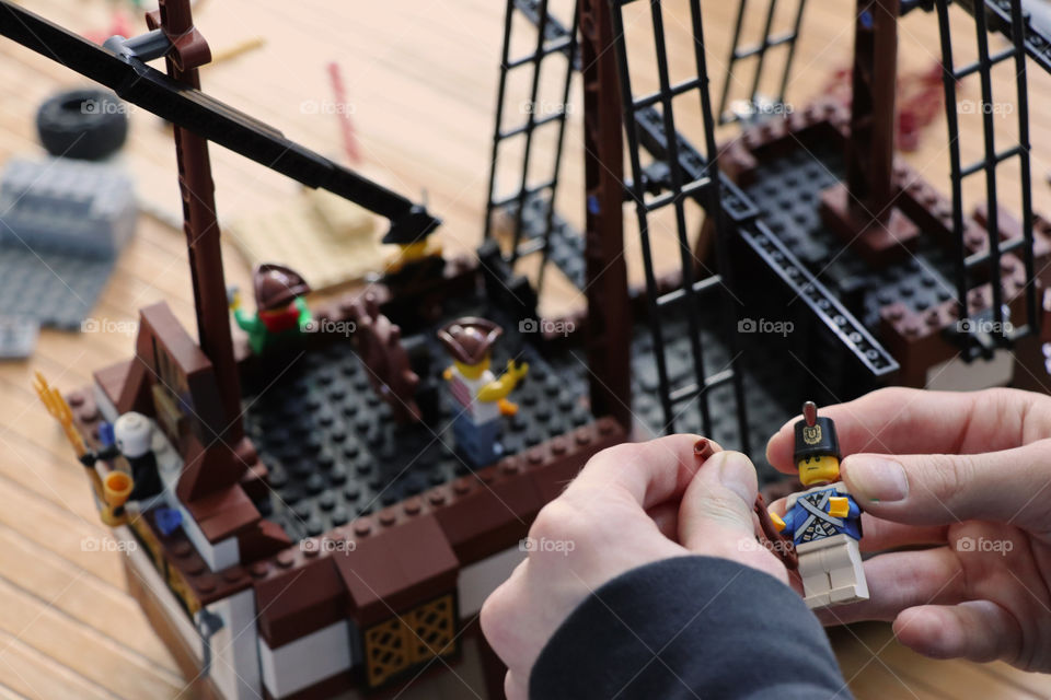 Boy playing with Lego pirates