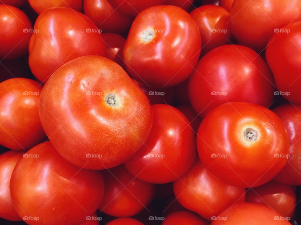 Fresh res tomatoes directly from above texture background 