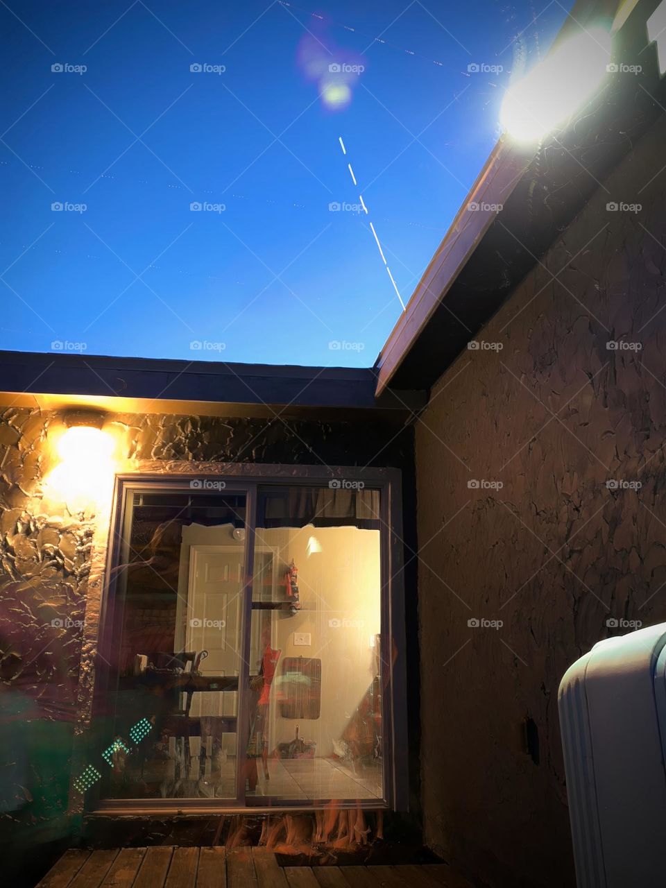 Star Trajectory Started Line From Its Motion Above The Top Of The House With Planes Motions And People Traces Long Exposure And Feet Going In And Out Of The Home.