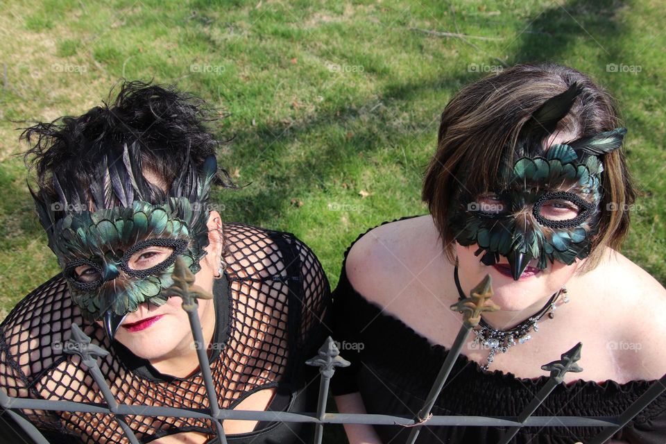 Woman wearing feather masquerade masks