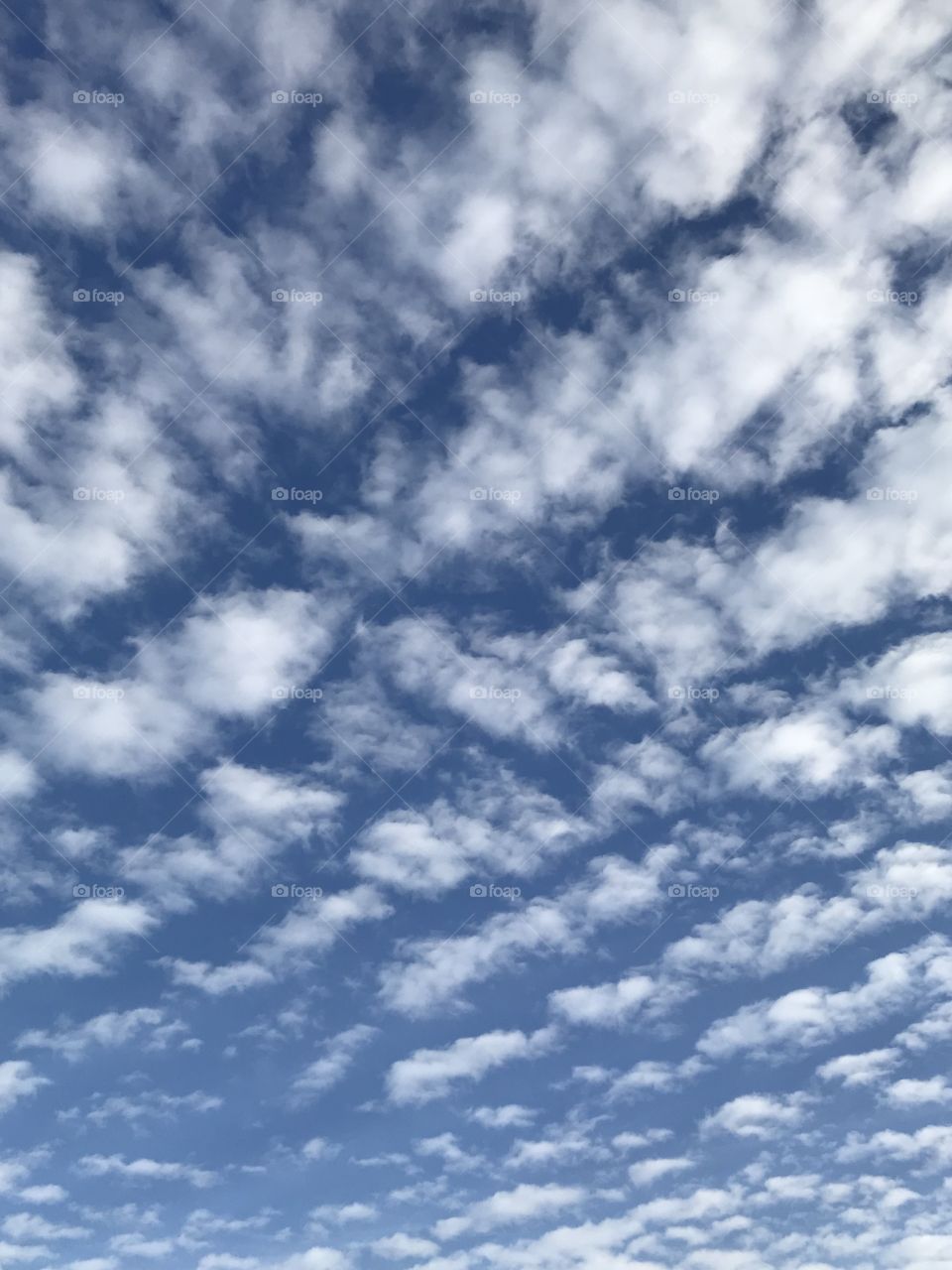 A Blue Sky With Rows Of Opaque Clouds