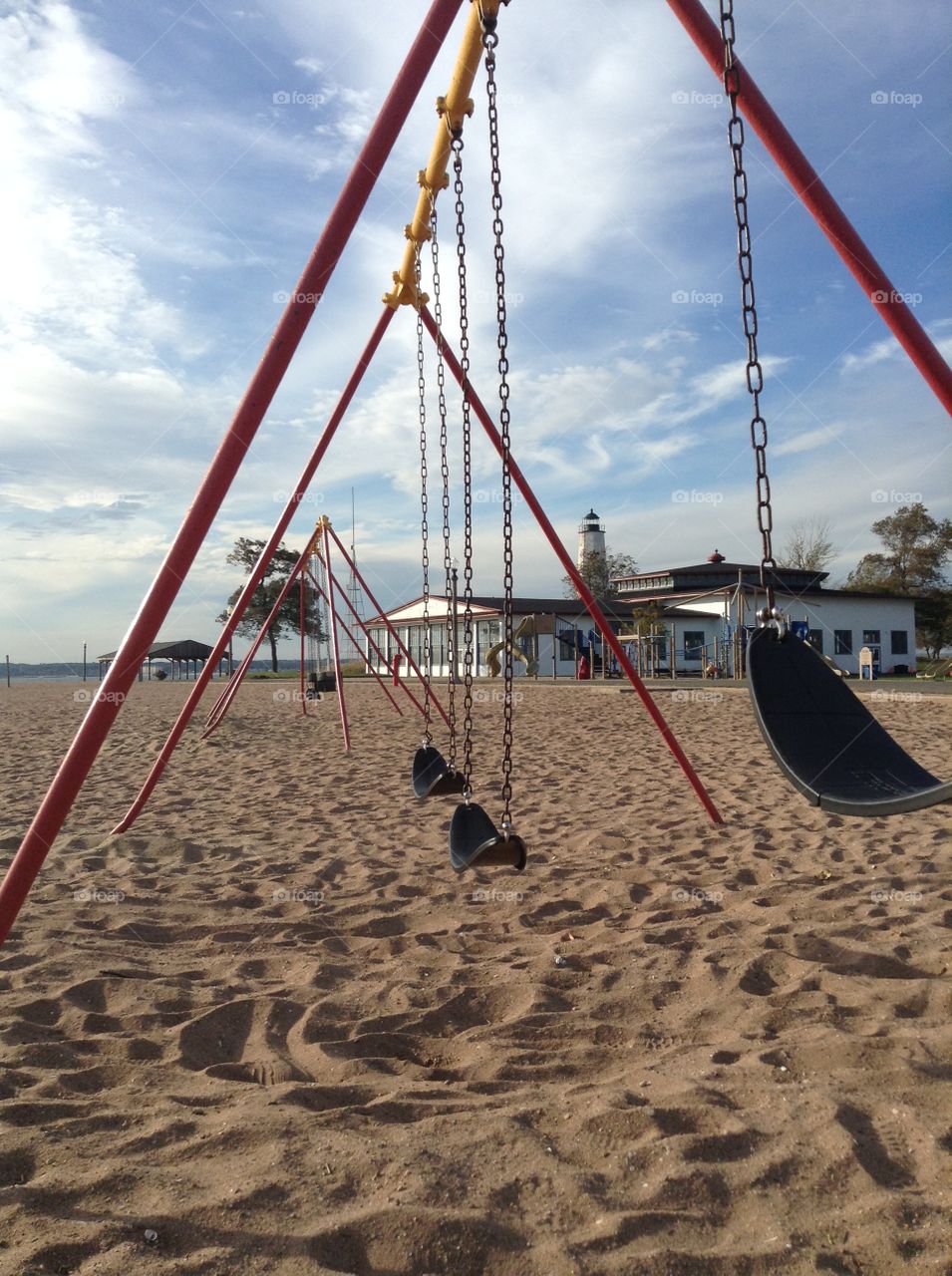 beach swingset with a lighthouse ocean view