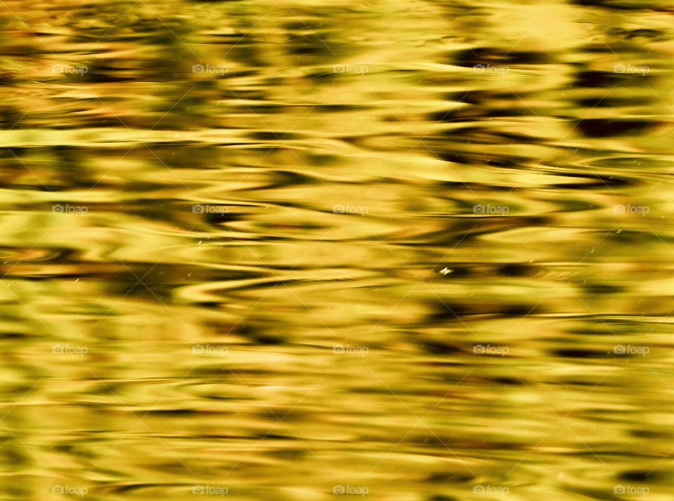 Light reflection on the surface of water - captured with slow shutter speed to have an oil painting effect 