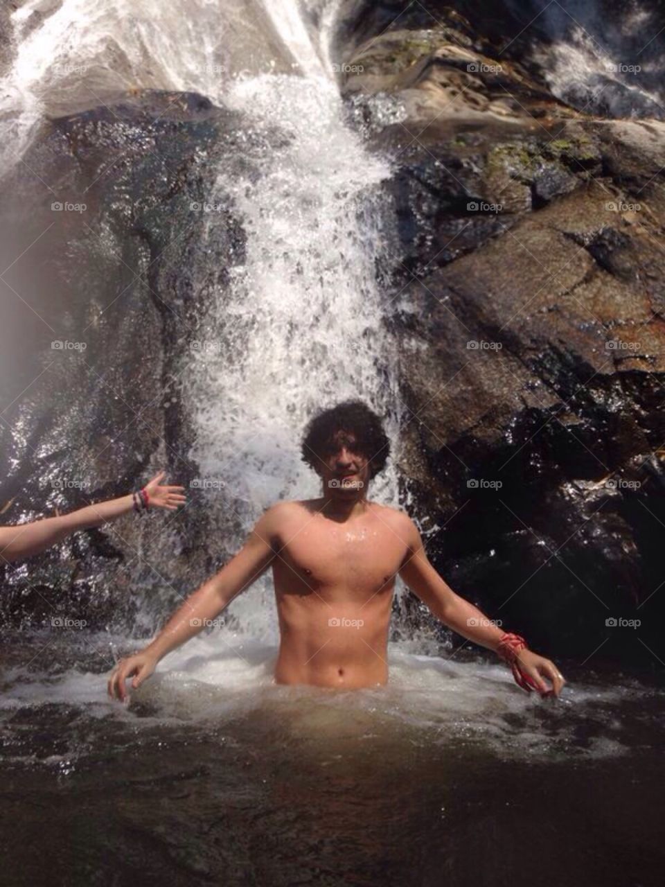 Man under waterfall 