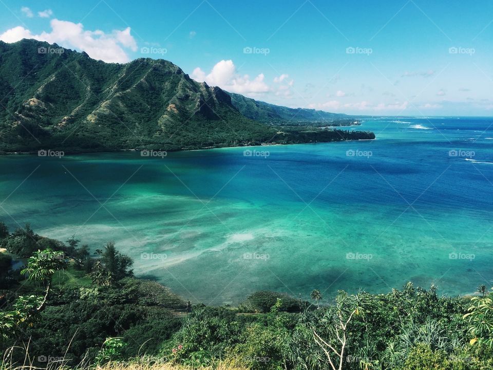 View of the bright blue ocean and the Hawaiian mountains.