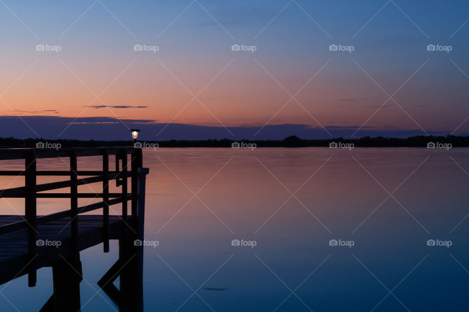 sunset at the lake under the deck