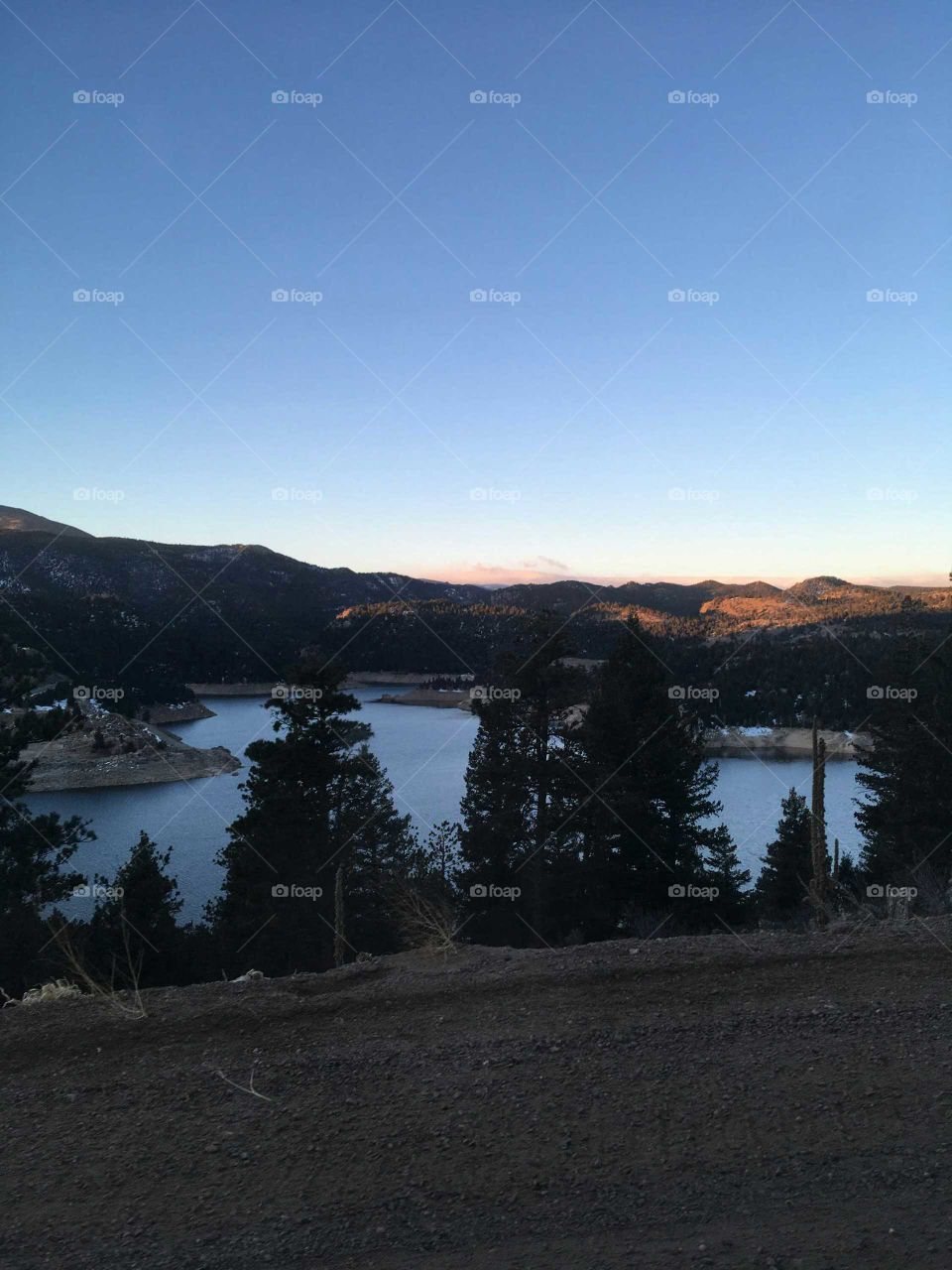 the glaze of  the sunset is breath taking an the water is like Cristal and the trees