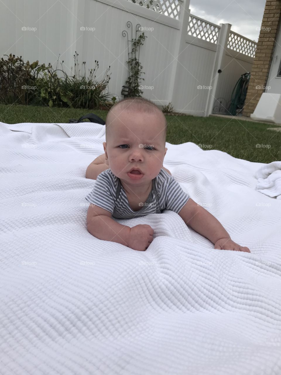 Baby boy enjoying tummy time in the outdoors for the first time