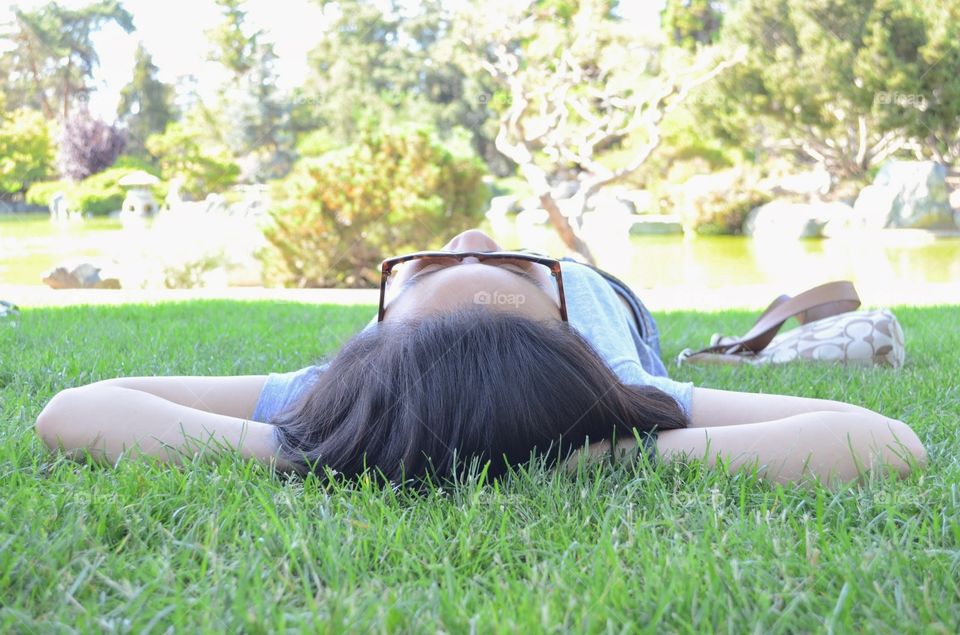 Relaxation. Summer isn't summer without laying out under a tree on the green grass.