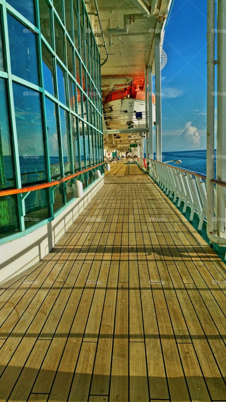 Deck 5. walking past tinted windows ofnmain dining room...As the sun is getting ready to set