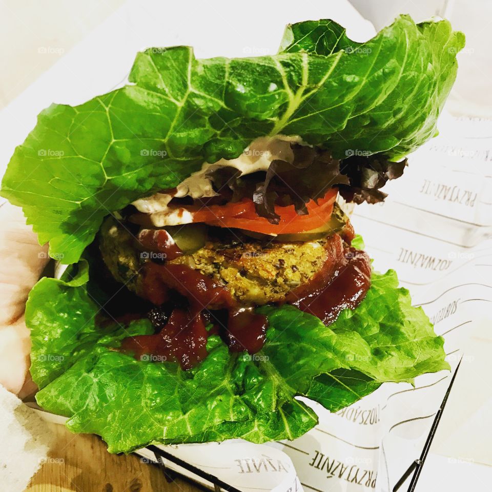 Vegan burger on salad leafs with ketchup and mayonnaise