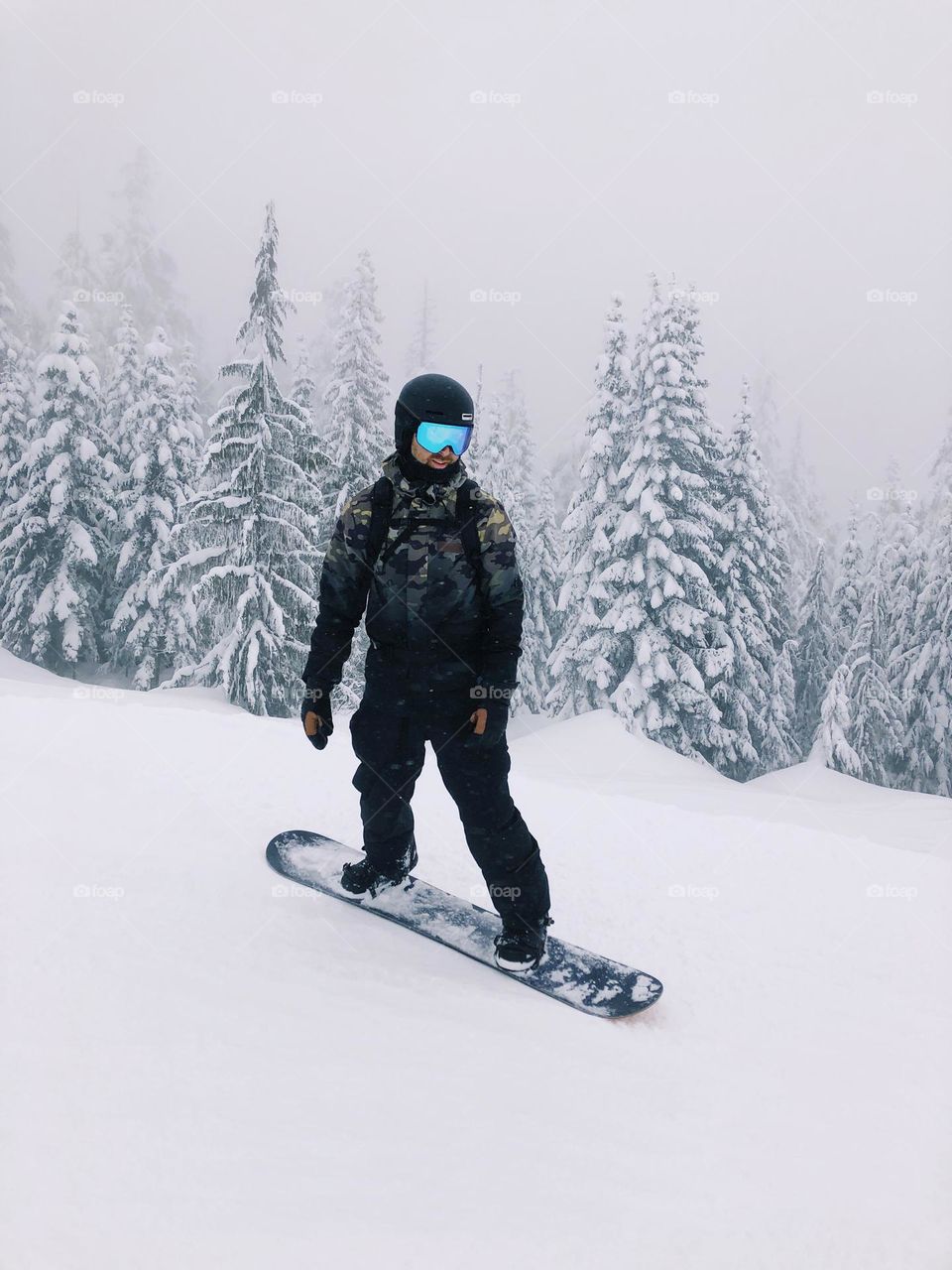 Man snowboarding in the forest