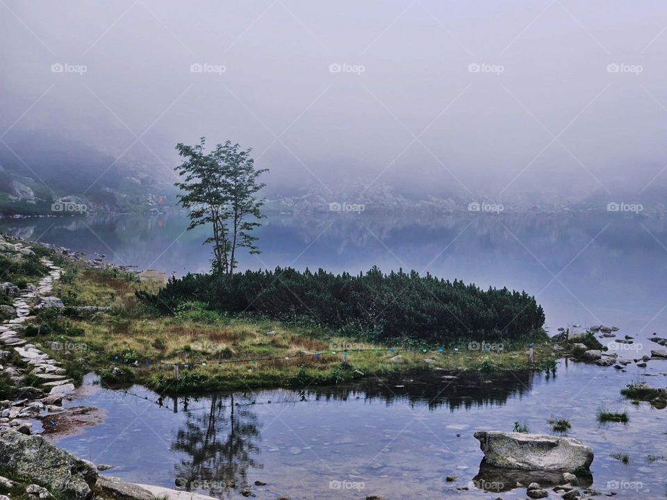 On the top of the mountain there was a lake and in this lake was a little island, behing there is even bigger mountain, but because of the mist this was our view that day