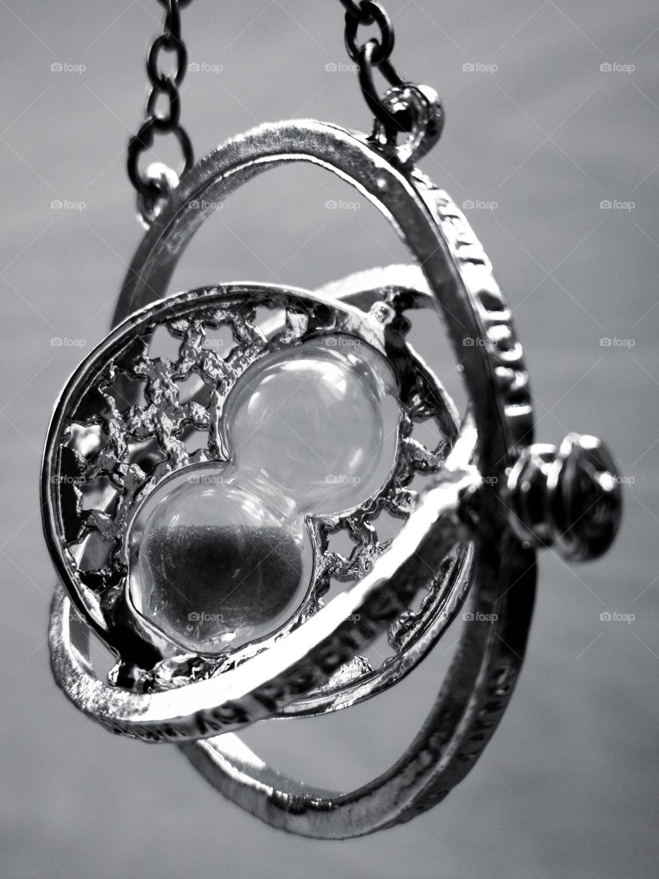 Women's pendant, which consists of rings.  Inside the pendant is an hourglass