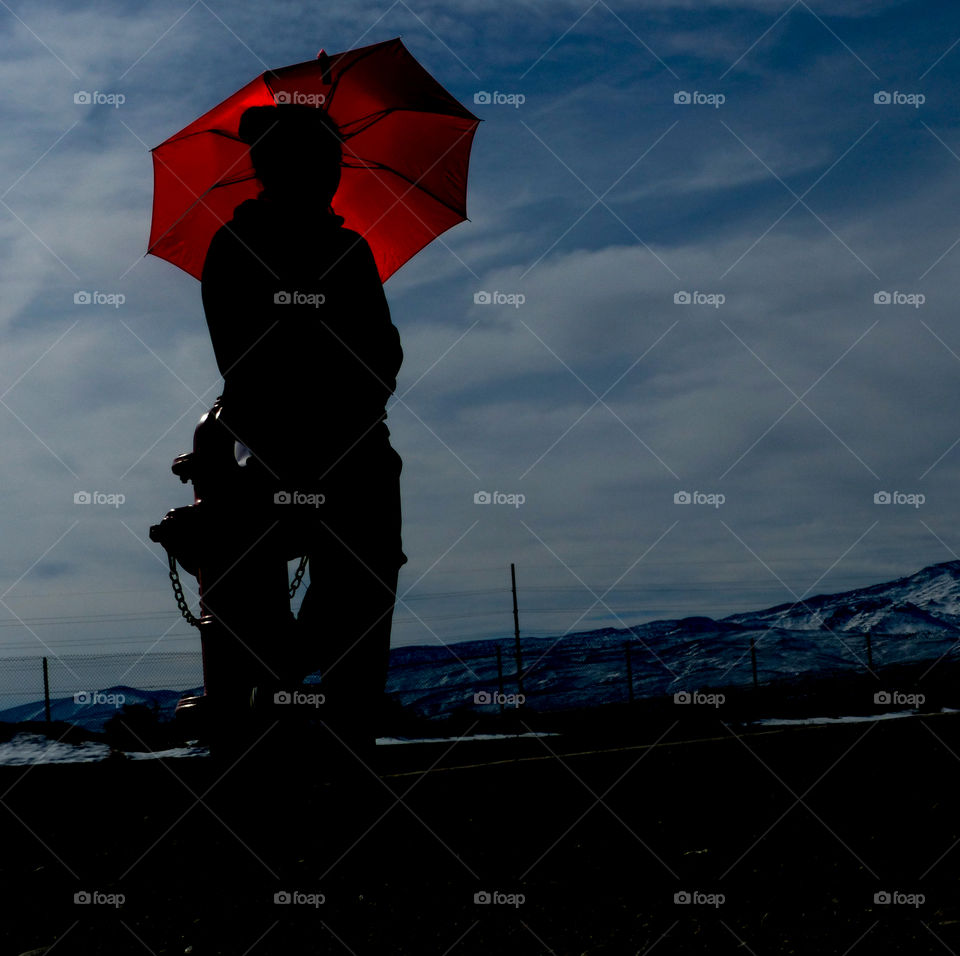A red umbrella with the silhouette