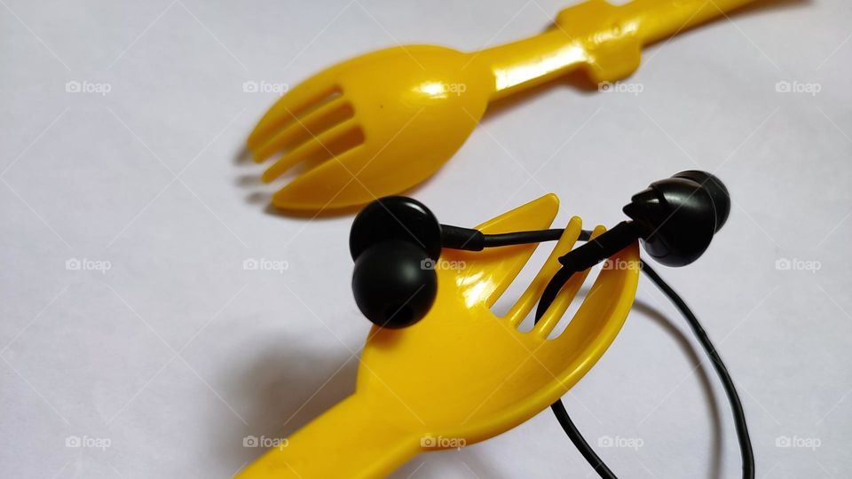 Yellow forks Trying to grab some music with earphones