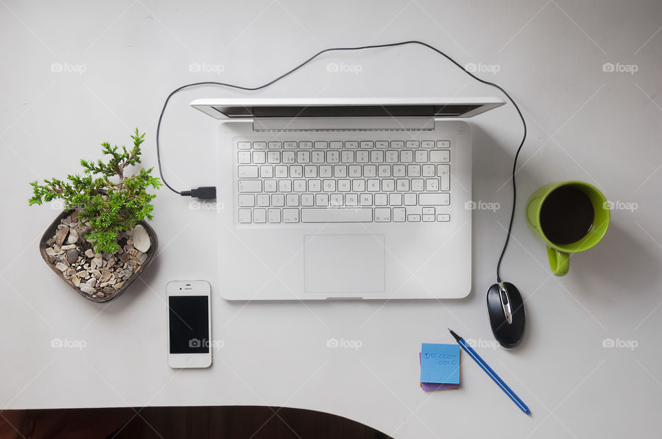 White laptop on white workspace