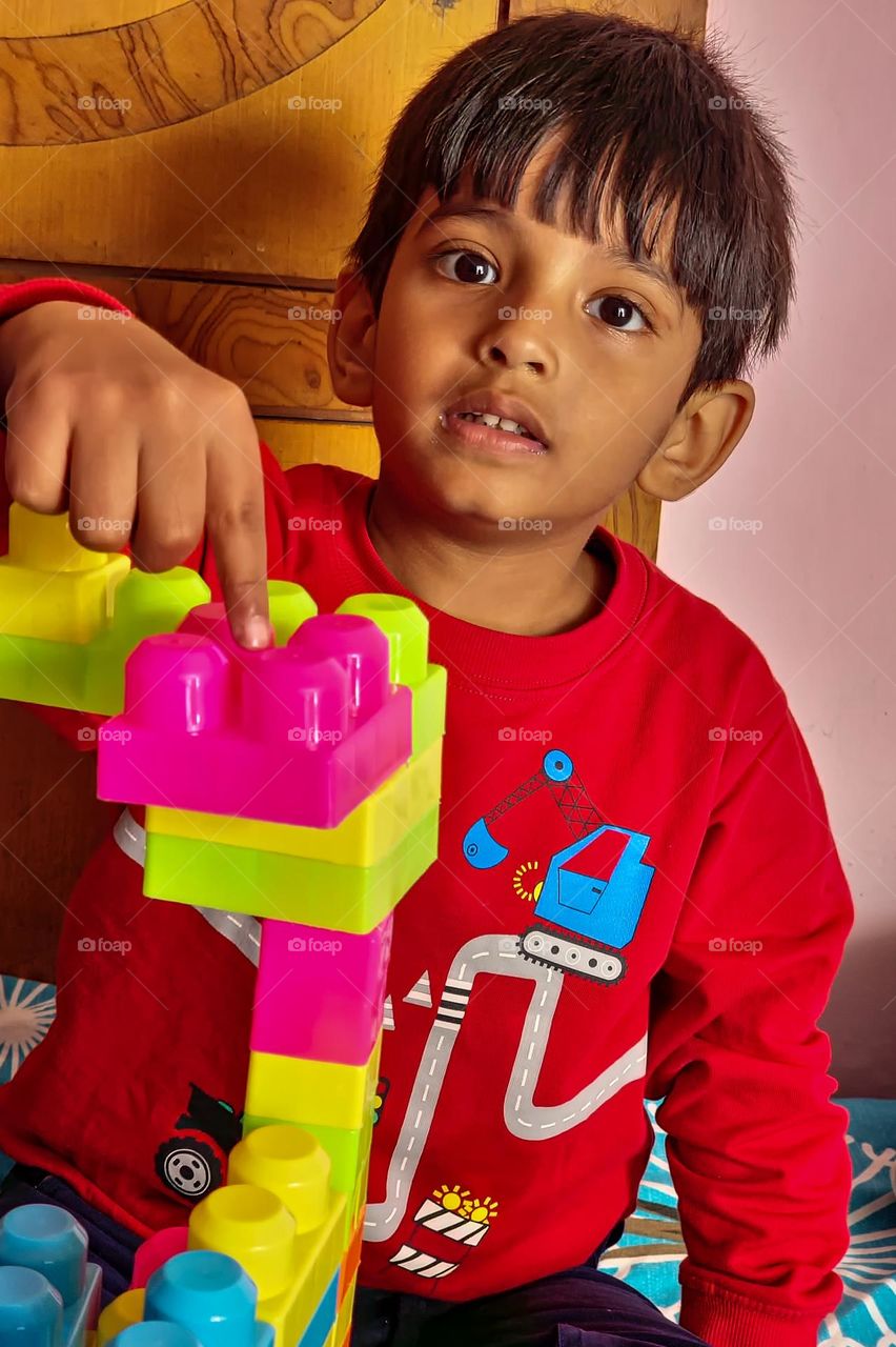 kid playing with building blocks
