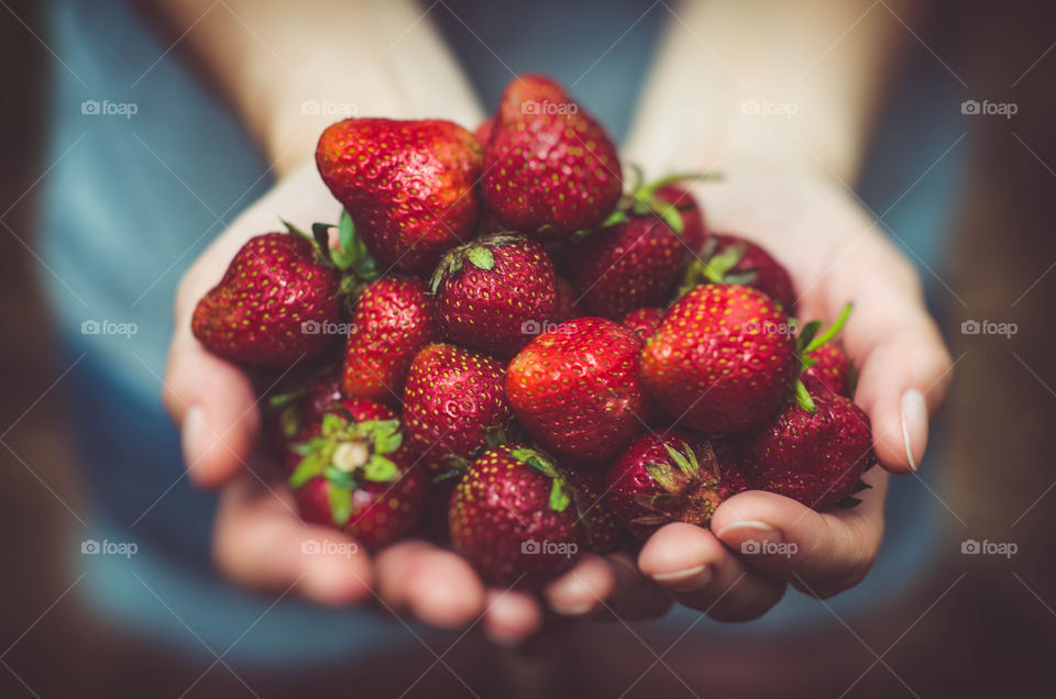 A handful of beautiful red strew berries