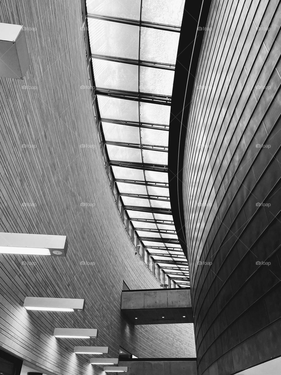 Black and white monochrome moden art museum curved corridor with high ceiling and light on the wall