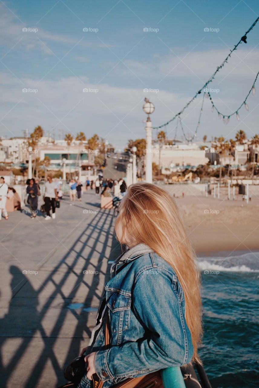 woman leaning on metal fence