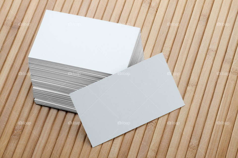 Blank white business cards on wooden background