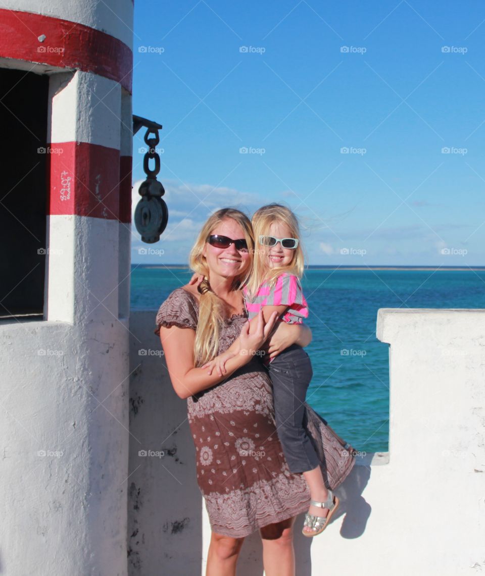 Mother and daughter visiting a lighthouse while traveling 