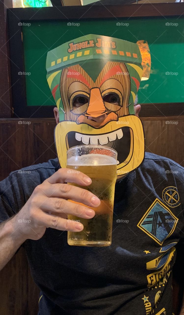 Tiki man drinking a beer 