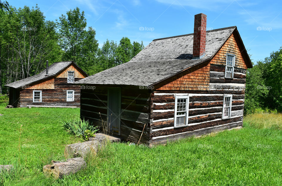 Rustic log cabins on a sunny summer day