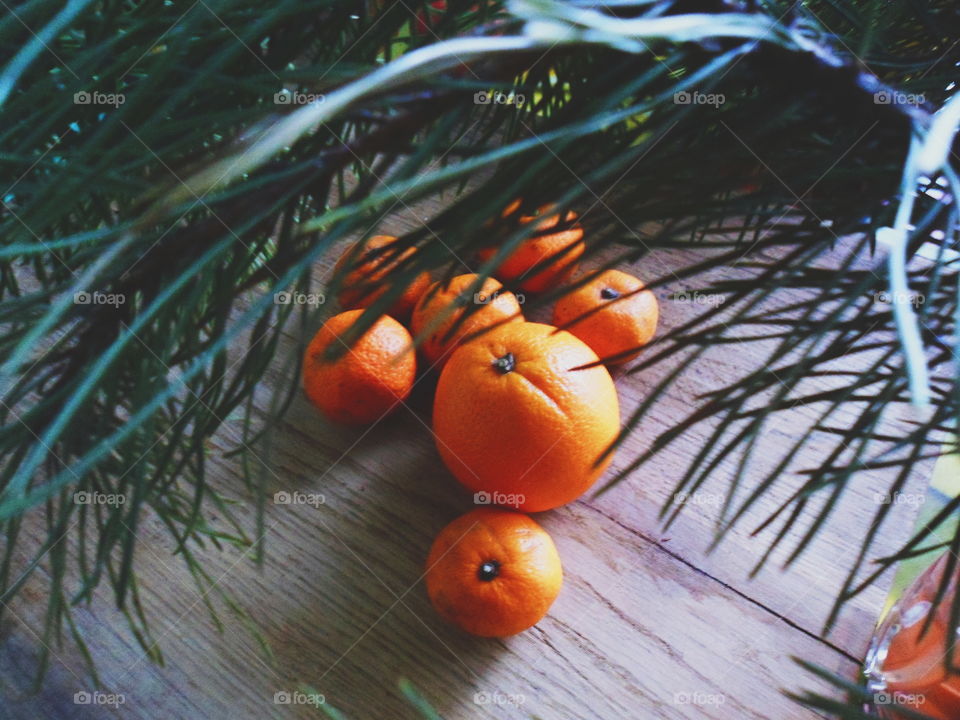 orange and tangerines are on the table