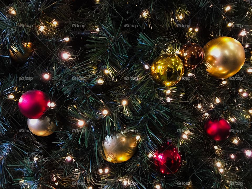 Christmas tree with red and golden baubles and lights 