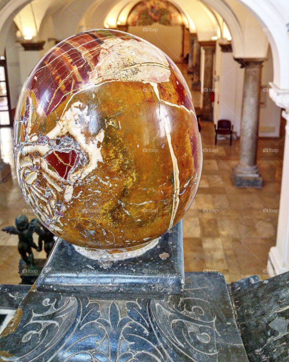 The inside view of Pepoli museum. Marble sphere.