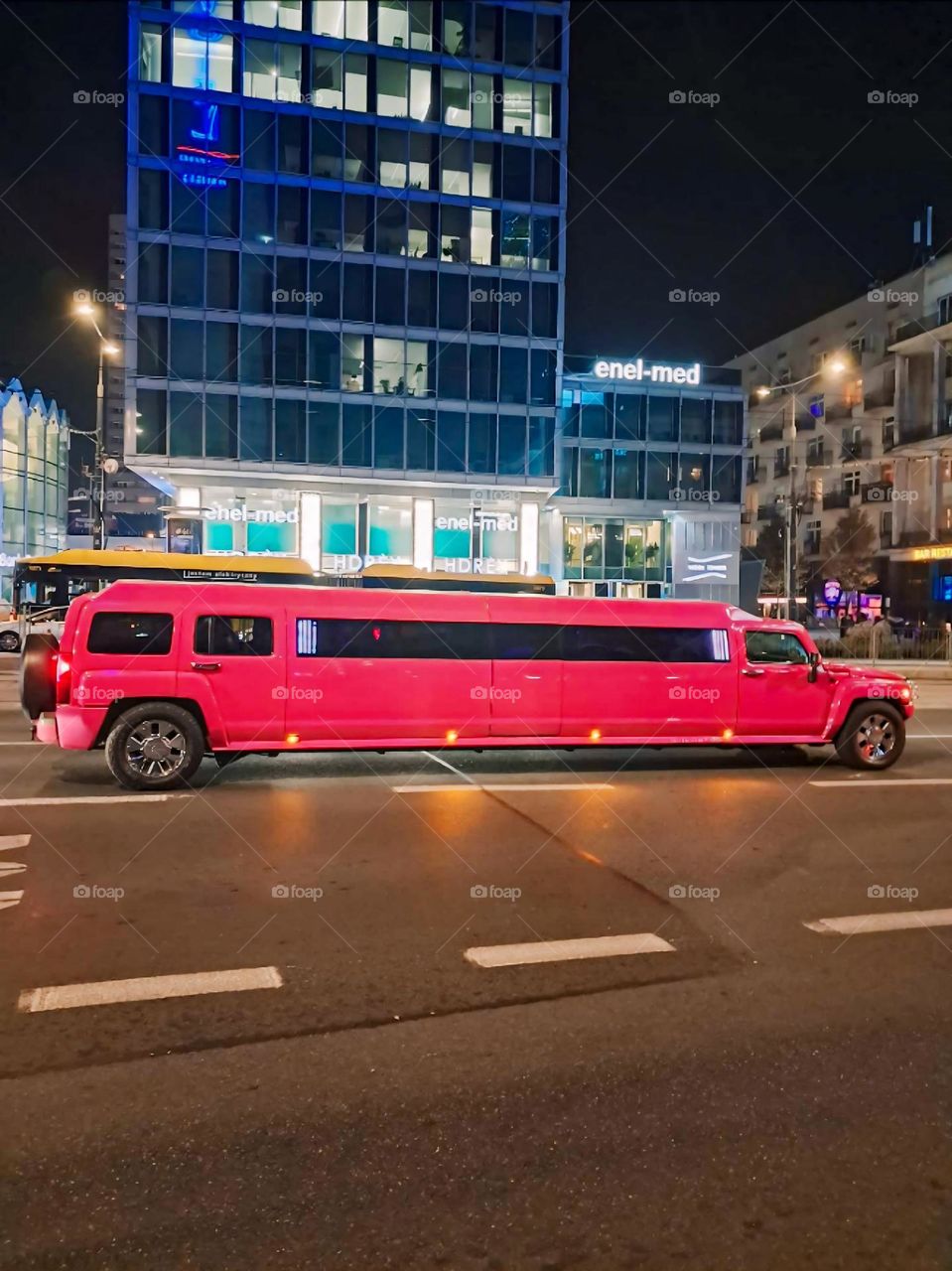 Red Stretch Hummer Limo at Night in Urban Setting