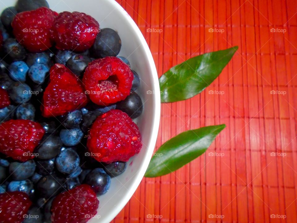 Raspberries and blueberries bowl