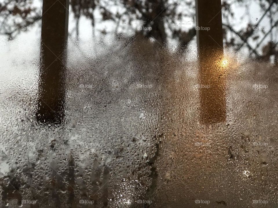Rqaindrops dancing with the soft evening light on the window, heralding hope or sorrow, serenity or agony?