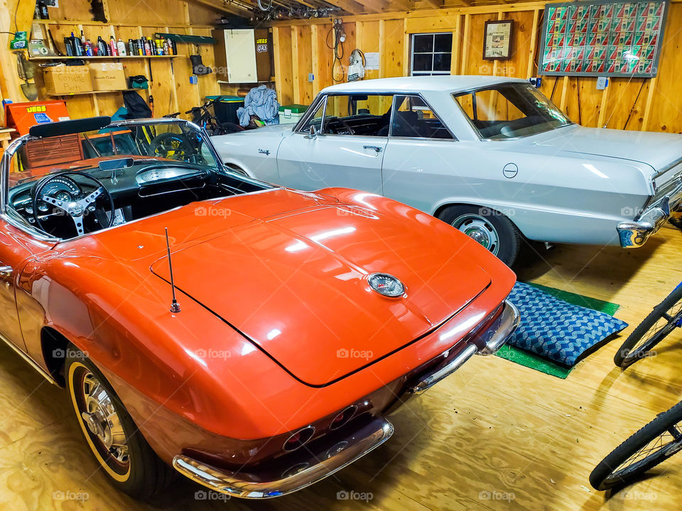 1962 Corvette and a 1964 Nova pose in a suburban American garage